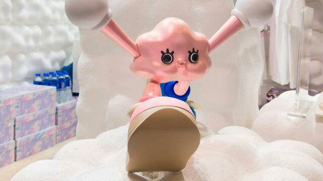 Lucius Sung Myeong Ha © the artist Pink cartoon character with large eyes and extended ears sits on fluffy white clouds