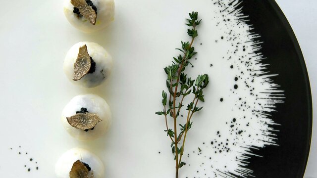 Plated dish featuring truffle and rosemary