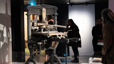 Visitors looking at Henry Parkes’ historic printing press