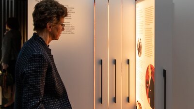 Woman looking at pull-out back-lit exhibition display