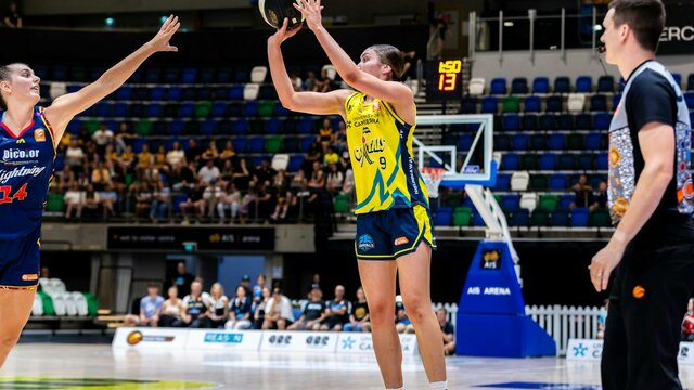 UC Capitals player shooting the basketball while a defender closes in.