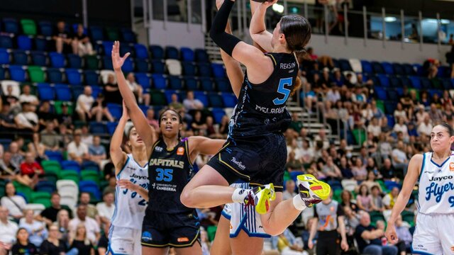UC Capitals player shooting the basketball while a defender closes in.