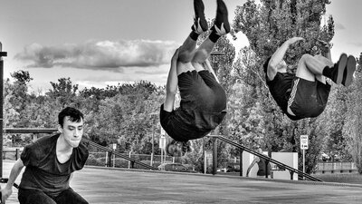 3 young men perform a backsault.