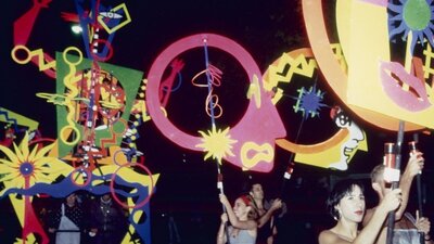 A photograph of people at a parade float.