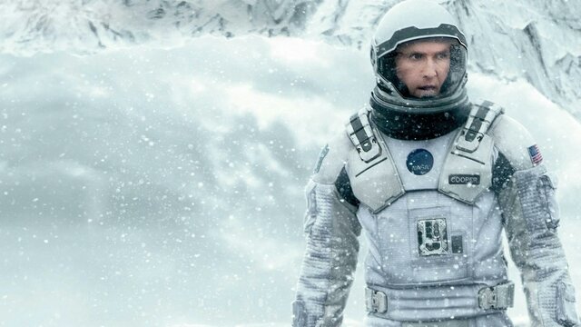 Interstellar Man wearing a space suit in snow surroundings