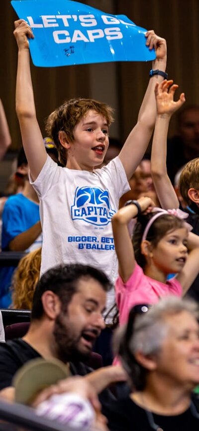 UC Capitals fans in the stands cheering for their team