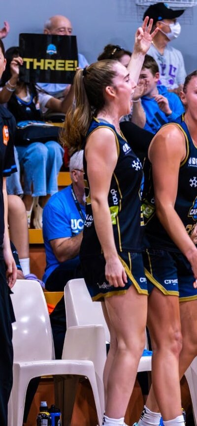 The bench players of a basketball team cheering.