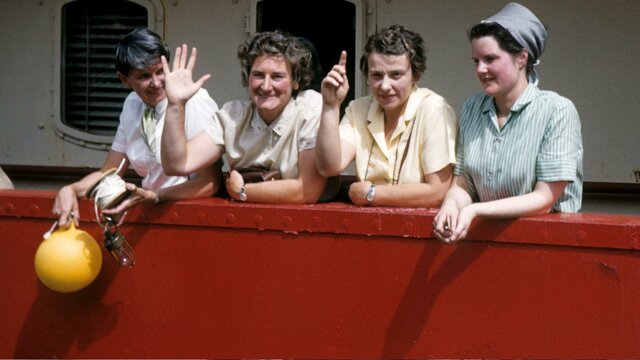 Preparing to embark for Macquarie Island on the MV Thala Dan in 1959 Four women smiling and waving on a boat.