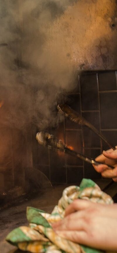 Chef in front of an open fire grill