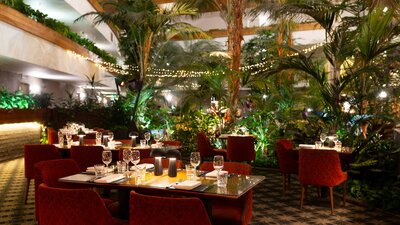 A shot of the Atrium at night - soft warm lights sit on indivual tables