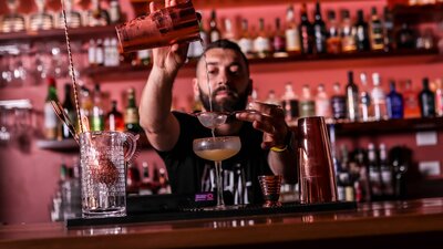 Bartender pouring a cocktail