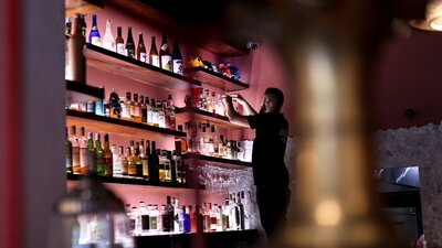 Bartender stocking shelves