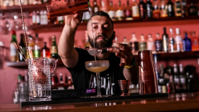 Co-Owner, Soumi Tannous Bartender pouring a cocktail