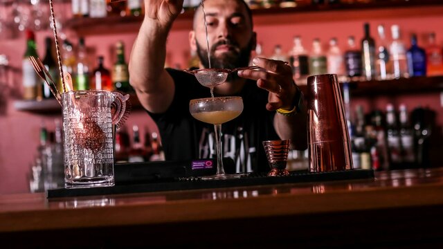 Co-Owner, Soumi Tannous Bartender pouring a cocktail