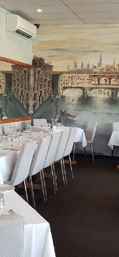 Empty restaurant setting with mural on wall