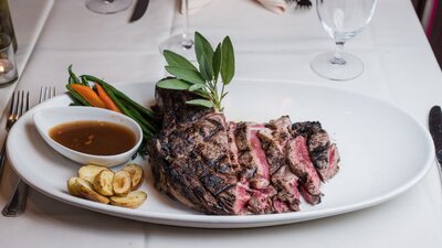 Steak and accompaniments on white plate