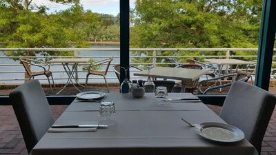 Empty table setting next to window overlooking lake