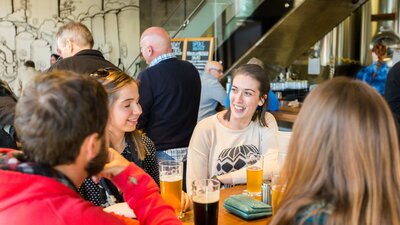 People having beers in the downstairs bar