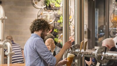 Barman pouring a tap beer