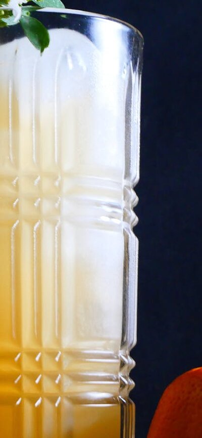 A Mandarin Gin 'Sonic' Cocktail Cocktail in a tall glass with a mandarin.