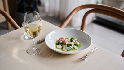 A dish of scallops and a glass of wine