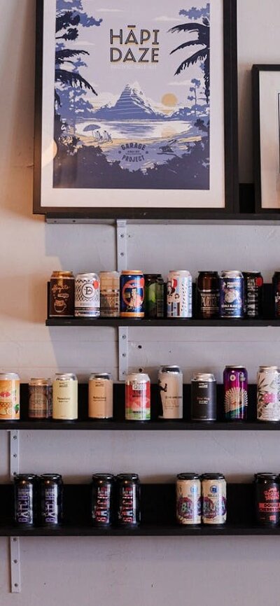 Wall shelf with beer tins sitting on it