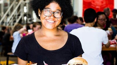 Lady holding burgers