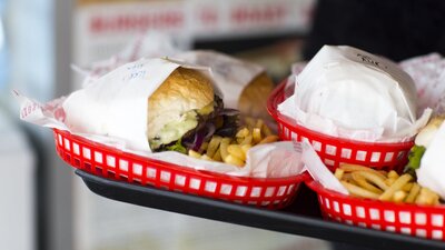 Plates of burgers and fries on a tray