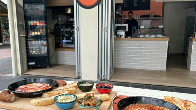 Various Cafe Cultura food offerings positioned on an outdoor table outside the cafe