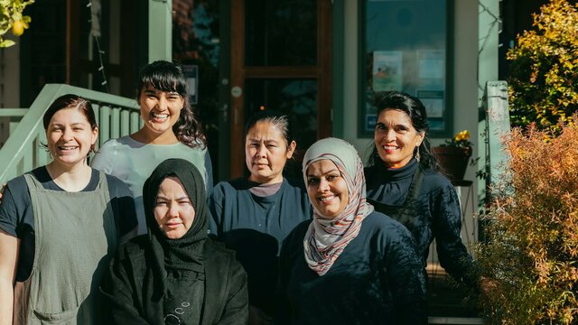 Staff on front steps of homestead Staff photo
