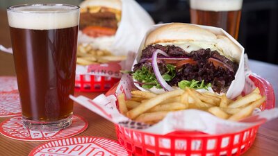 Beer and two burgers with chips