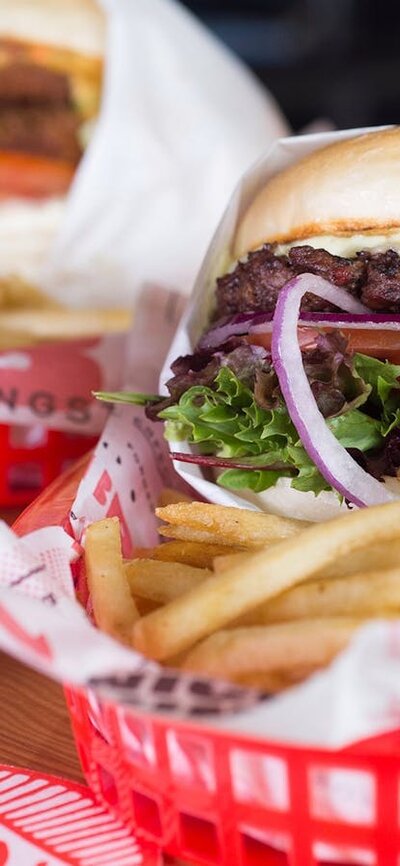 Beer and two burgers with chips