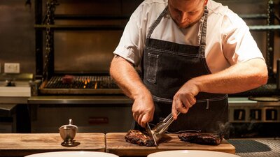 Chef cutting steaks