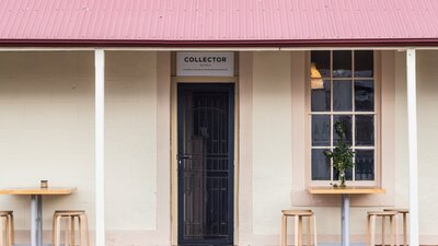 Cafe stools and tables sit outside the entrance to the Collector Wines cellar door.
