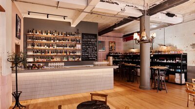 Bar with shelf full of different wines