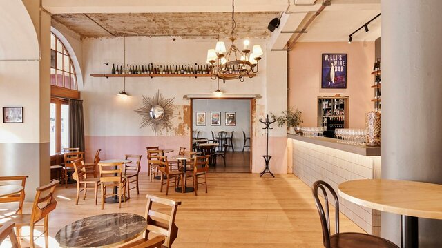 Dear Prudence Bar Room with tables and chairs and natural light from sun