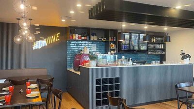 Internal view of empty restaurant with yellow Divine light on wall