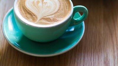 Cup of coffee with a love heart on top