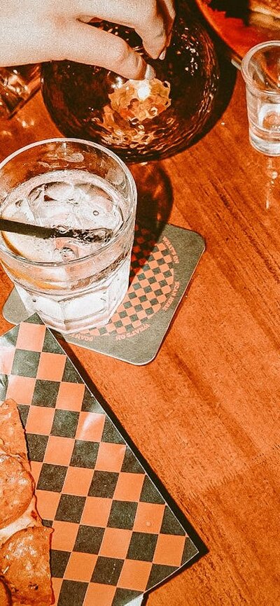 Photo of pizza by the slice and drinks on table