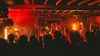 Photo of bank on stage and crowd in foreground