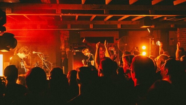 Photo of bank on stage and crowd in foreground