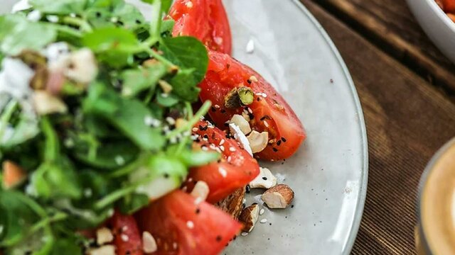 Plate showing colourful meal and coffee cup