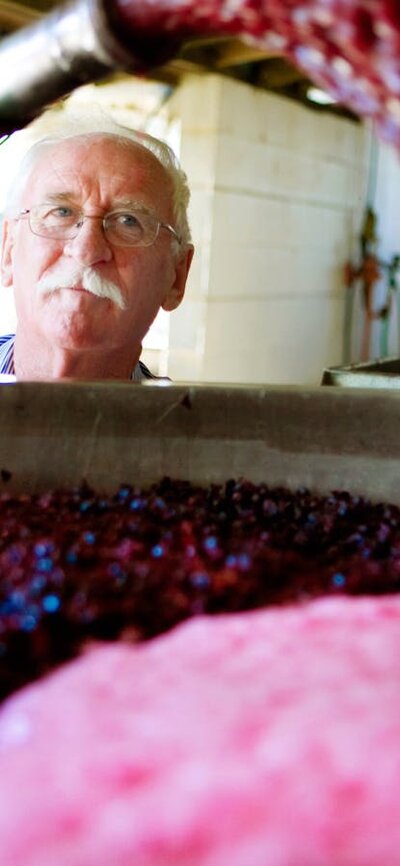 Wine maker Ken Helm at work with the vats