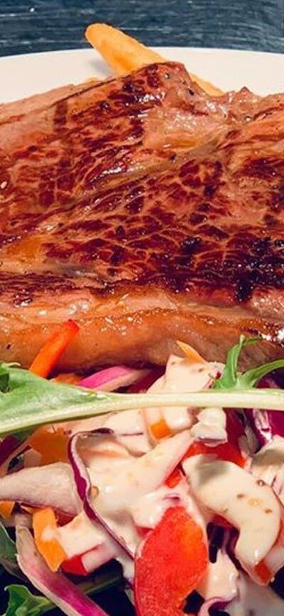Hibernian Hotel Steak on a plate with salad