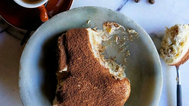 Italian dessert plated on a table with coffee on the side