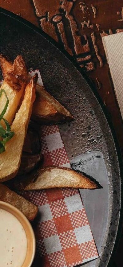 Burger and fries plated on a wooden table