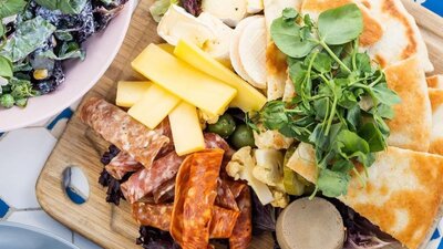 A platter of food presented on a wooden board.