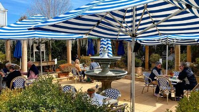 An outdoor cafe with large umbrellas to provide shade