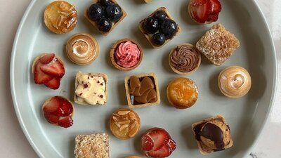 A collection of mini tarts on a plate.