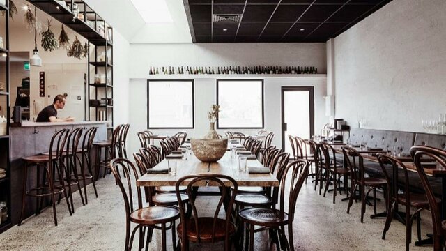 Empty restaurant with tables set ready for service